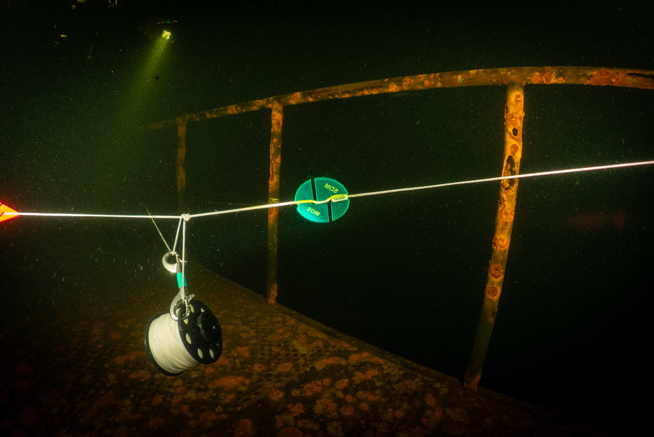 Custom cave marker on a guideline inside a wreck