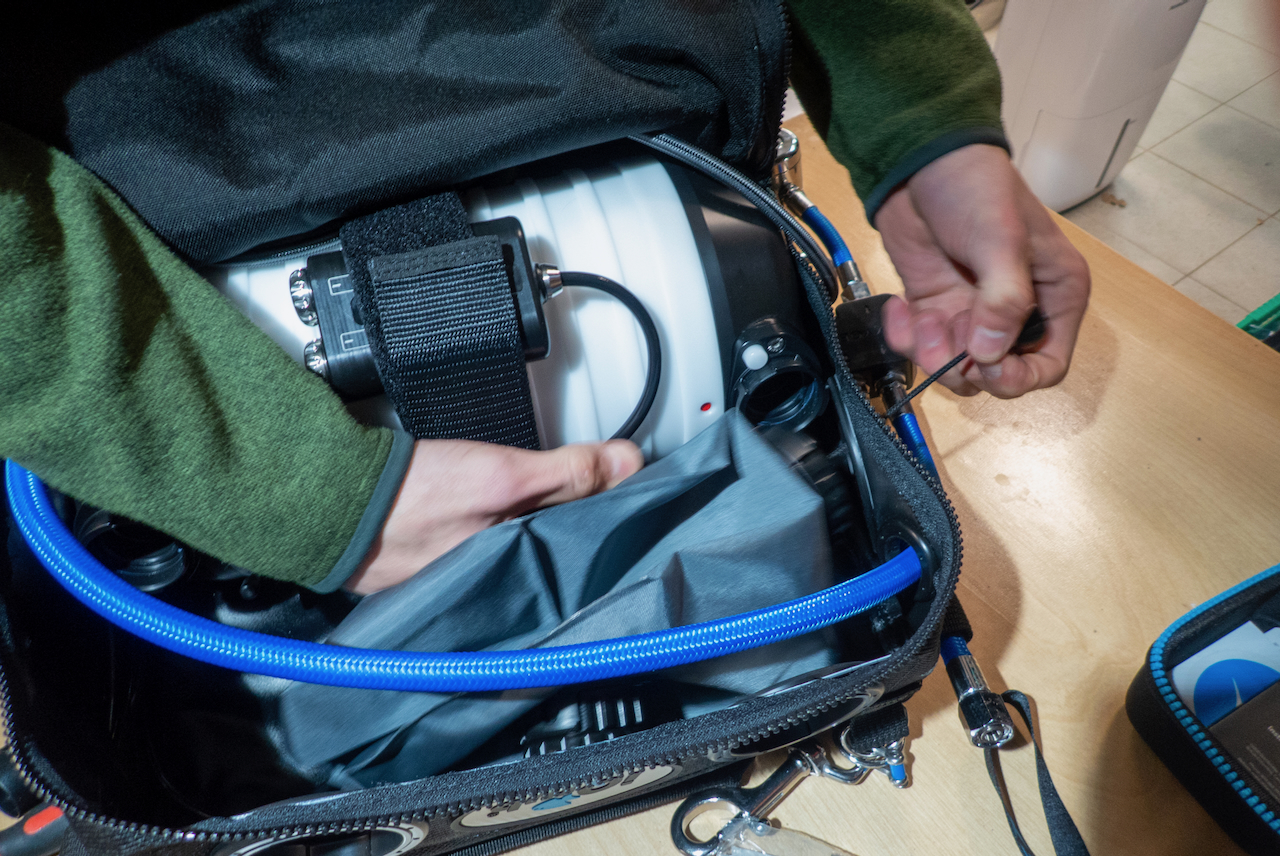 Fitting the HUD module into position in the bag