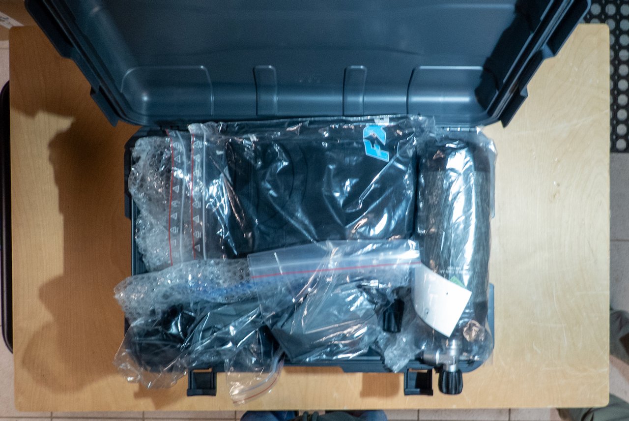 Case opened showing all components wrapped in plastic