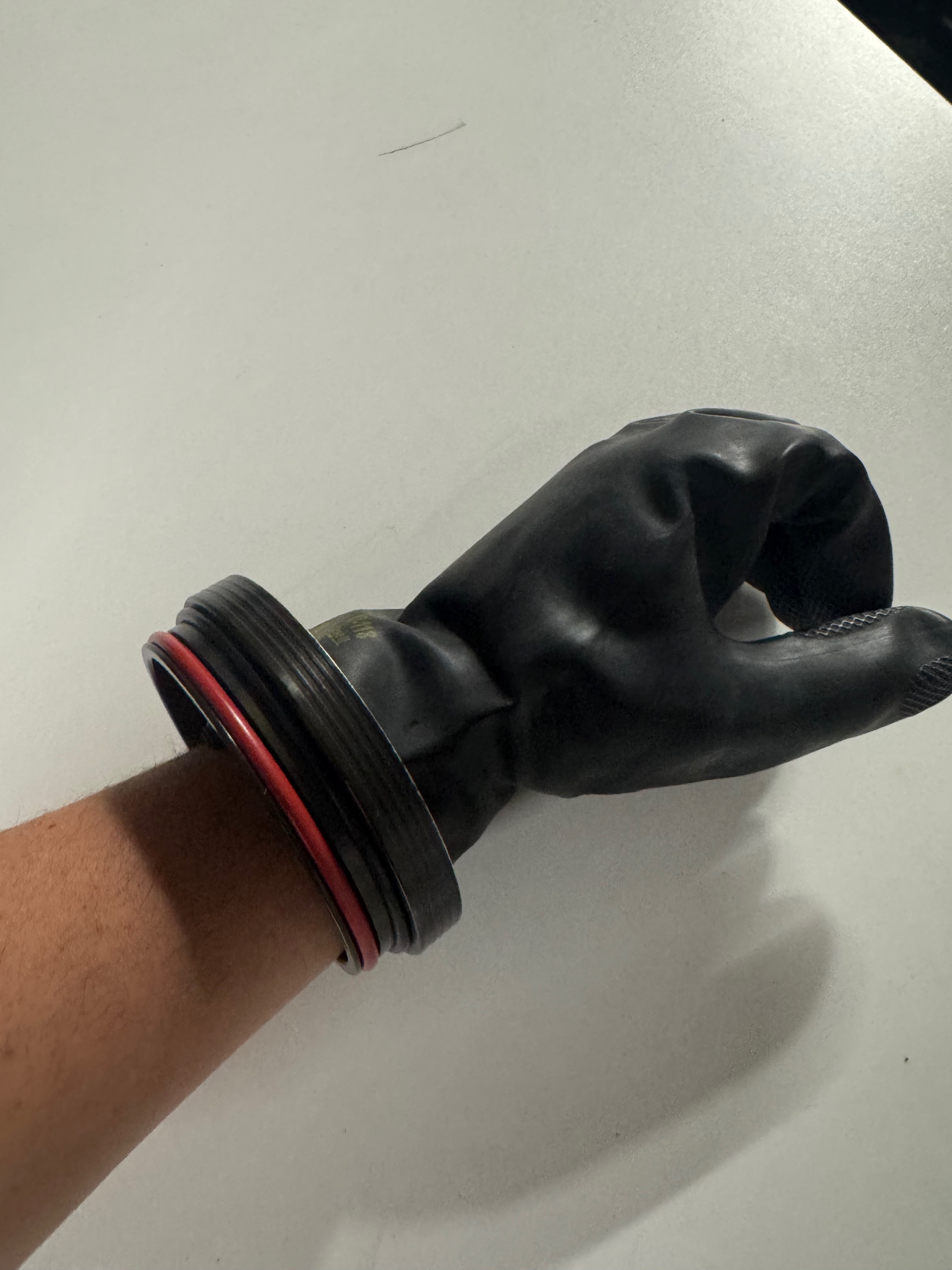 Kubi dry glove assembly on a wrist, red o-ring seated