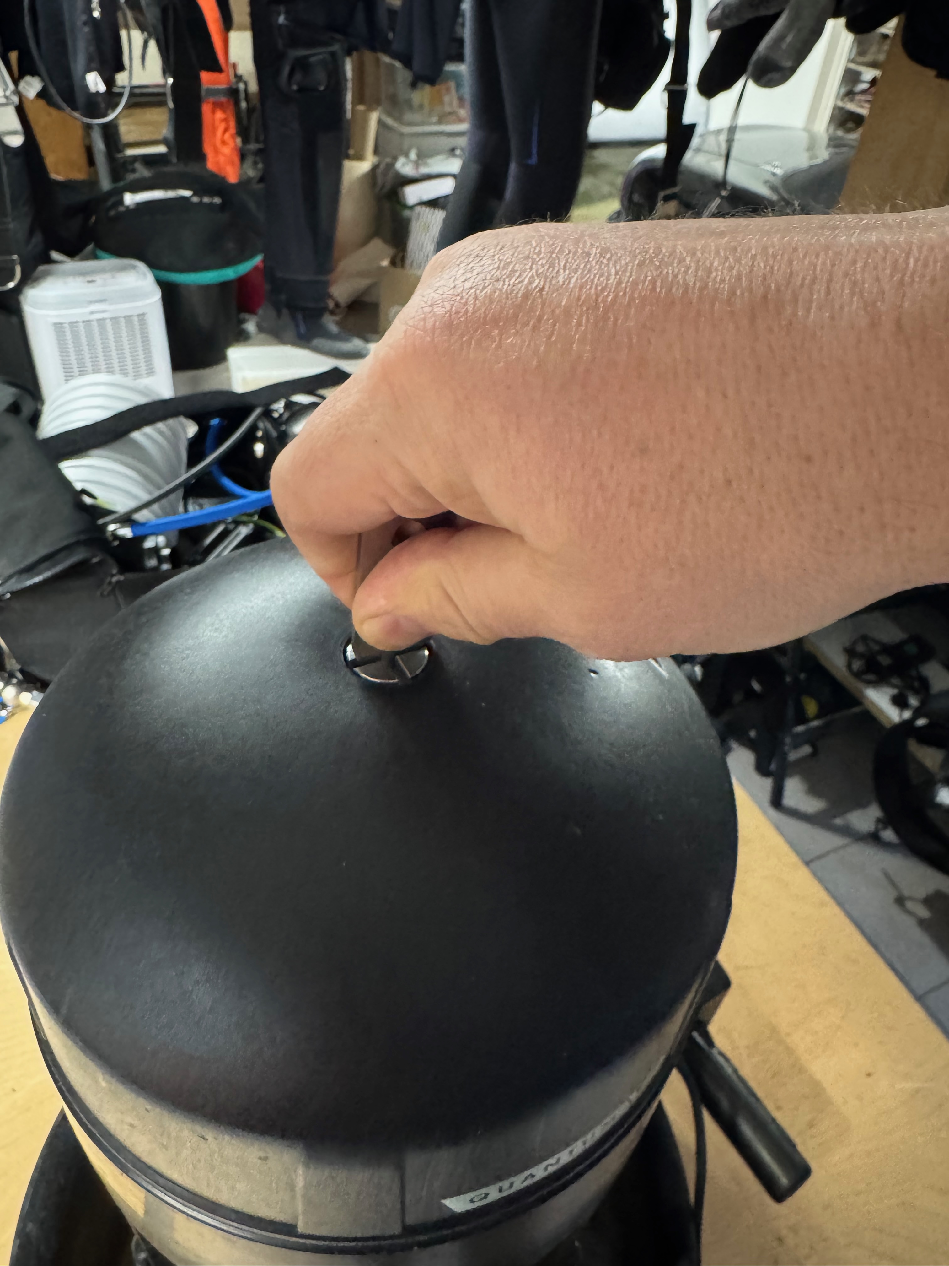 Unscrewing the nosecone retaining screw on the SUEX Quantum VR