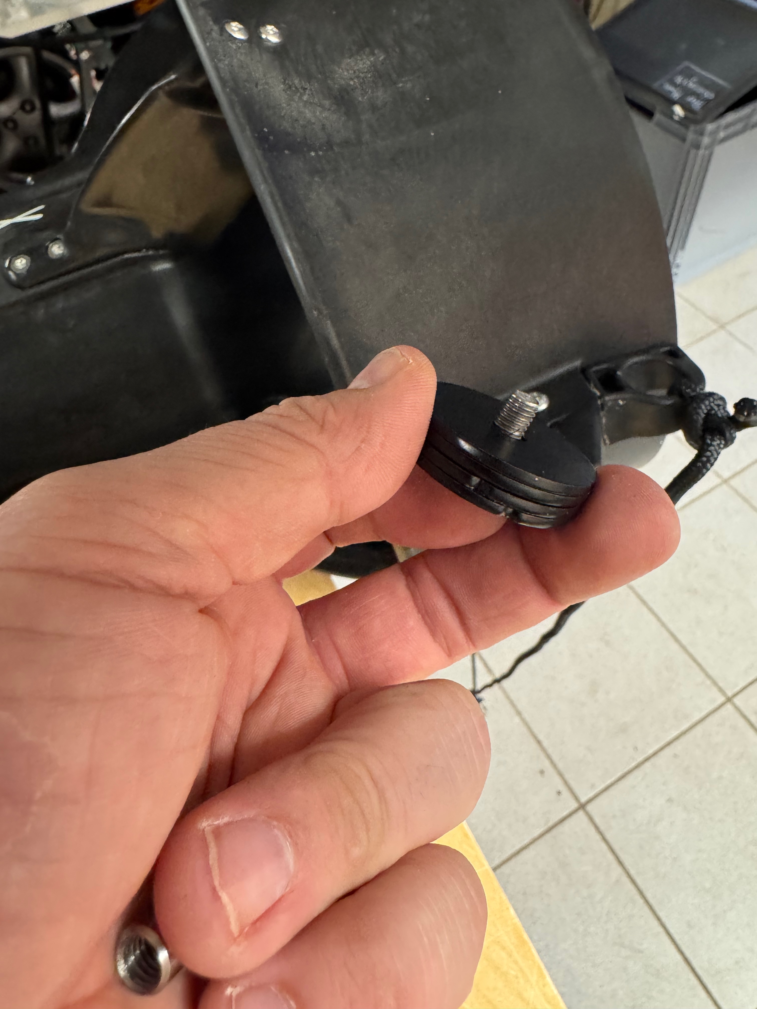 Weight disc stack removed from the bracket, showing bolt, cap, and discs